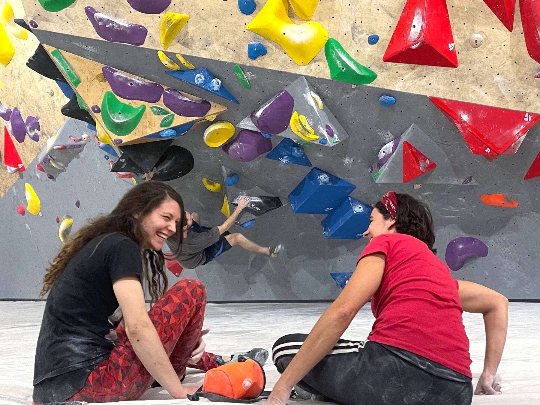 Climbers resting and sharing the gym space at Kivi